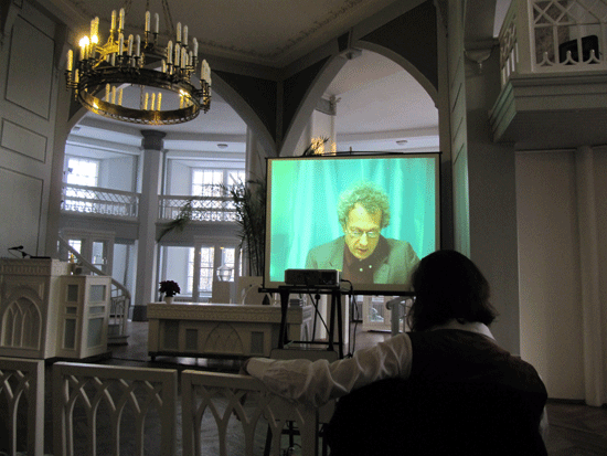 image of speaker delivering talk by video