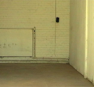 photograph of speaker no in warehouse - with radiator and painted wall