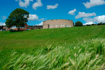 image of round concrete building on walk
